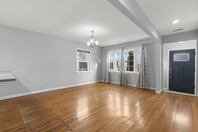 entrance foyer with a chandelier and hardwood / wood-style flooring