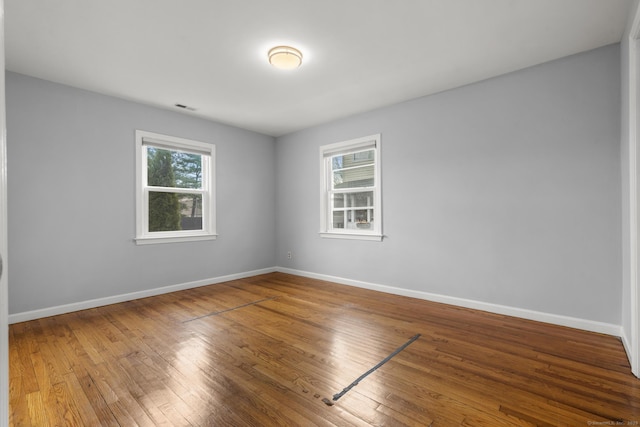 spare room featuring wood-type flooring