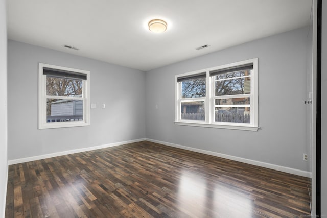 unfurnished room featuring dark hardwood / wood-style floors