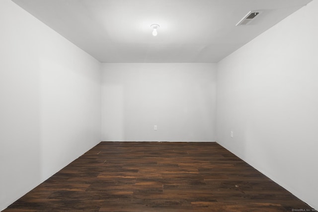 spare room with dark hardwood / wood-style floors