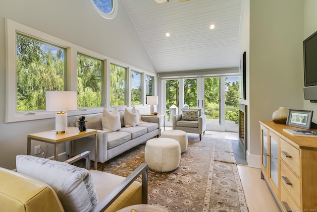 sunroom / solarium featuring wooden ceiling, lofted ceiling, and plenty of natural light