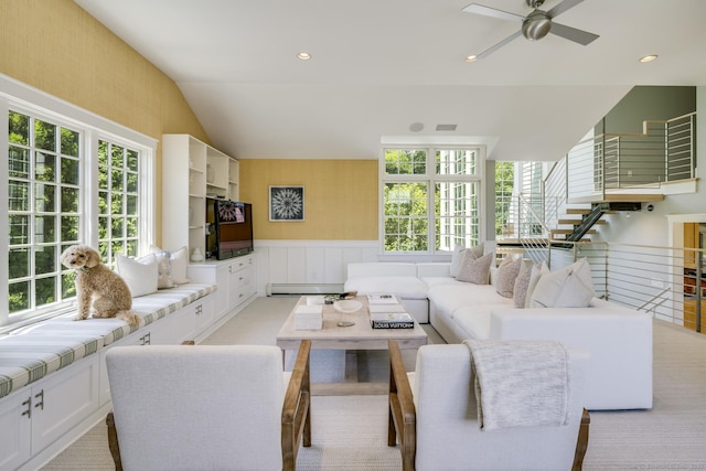 living room featuring ceiling fan, baseboard heating, and lofted ceiling