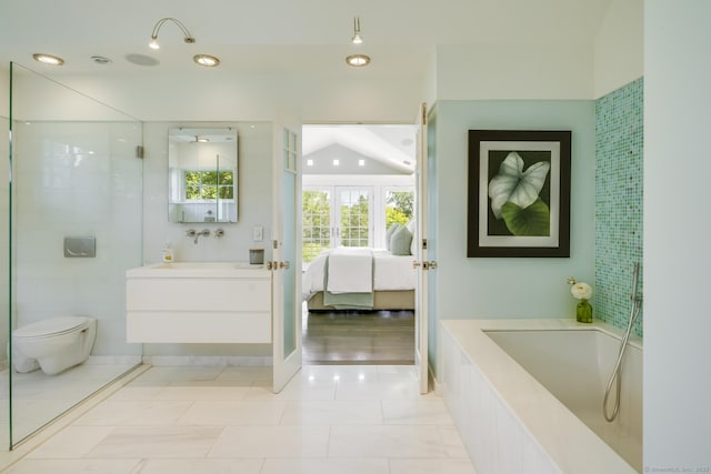 bathroom with toilet, vanity, tile patterned flooring, and french doors