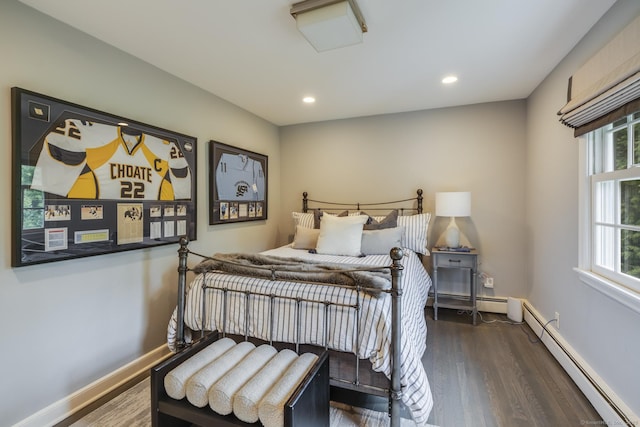 bedroom with dark wood-type flooring and baseboard heating