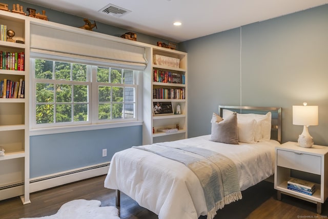 bedroom featuring baseboard heating and dark hardwood / wood-style flooring