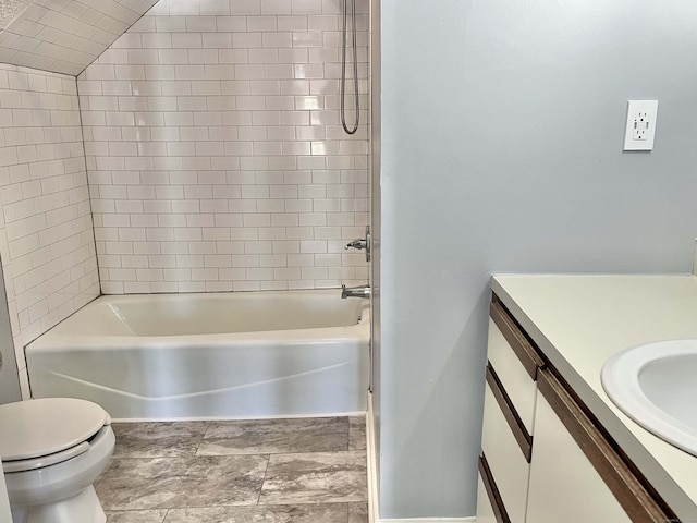 full bathroom featuring toilet, tiled shower / bath combo, and vanity