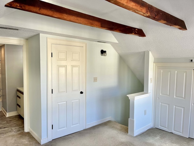 bonus room featuring lofted ceiling and light colored carpet