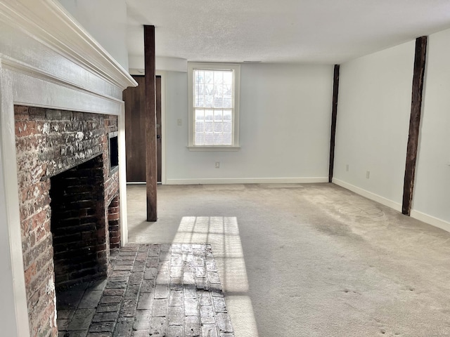 unfurnished living room featuring a brick fireplace, a textured ceiling, and carpet flooring