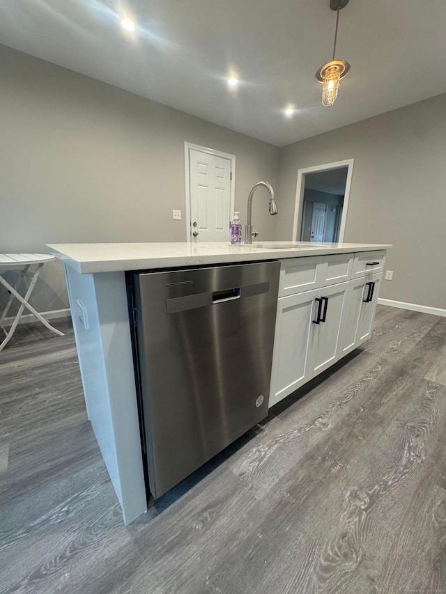 kitchen with dark wood finished floors, white cabinetry, light countertops, baseboards, and dishwasher