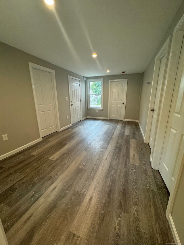 unfurnished bedroom featuring dark wood finished floors and baseboards