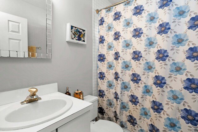 bathroom featuring vanity, a shower with shower curtain, and toilet