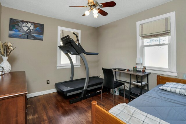 bedroom with a textured ceiling and dark hardwood / wood-style flooring