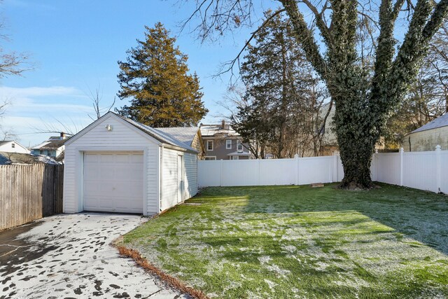 view of yard featuring a garage and an outbuilding