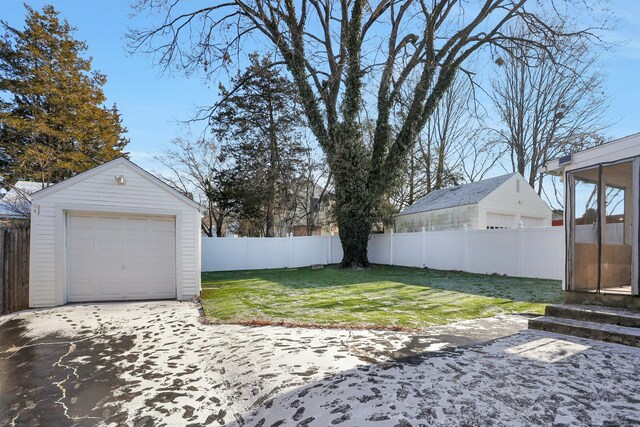 view of yard featuring a garage, an outdoor structure, and a patio area