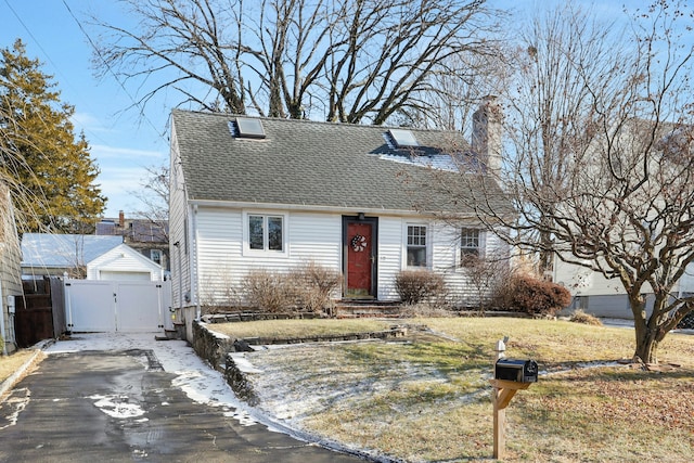 cape cod home with a front yard