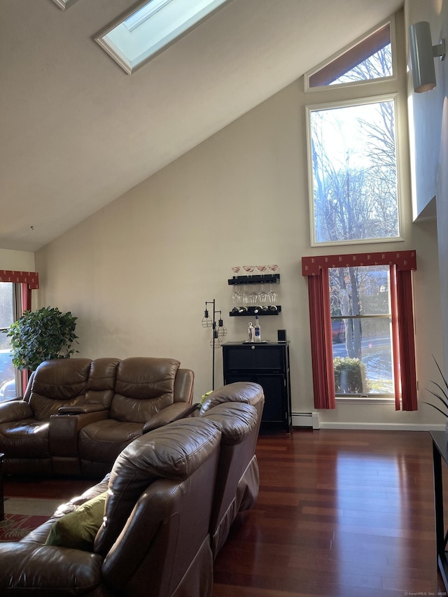 living room featuring baseboard heating, dark hardwood / wood-style floors, and lofted ceiling with skylight