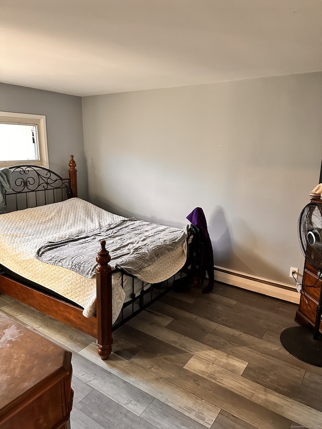 bedroom featuring hardwood / wood-style flooring and a baseboard radiator