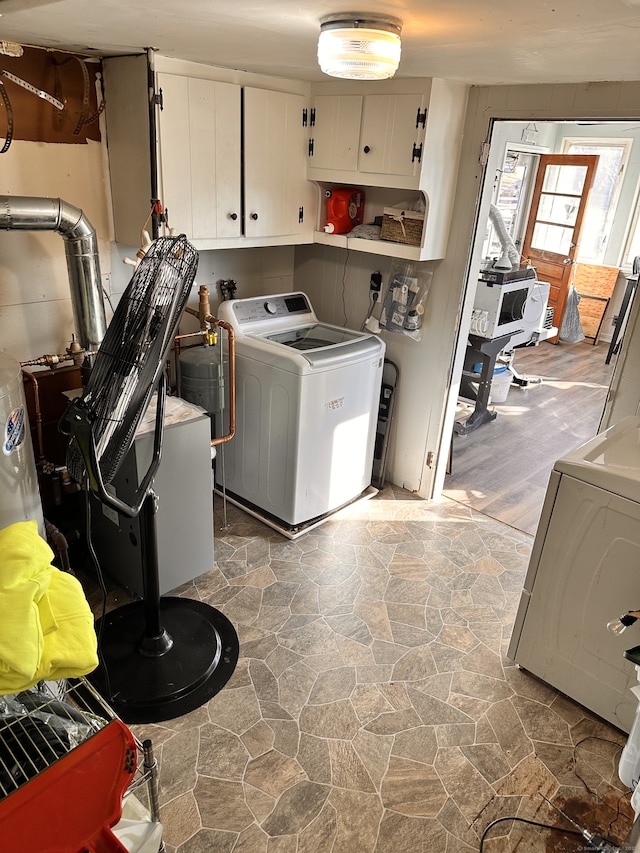 laundry area featuring cabinets and washer and clothes dryer