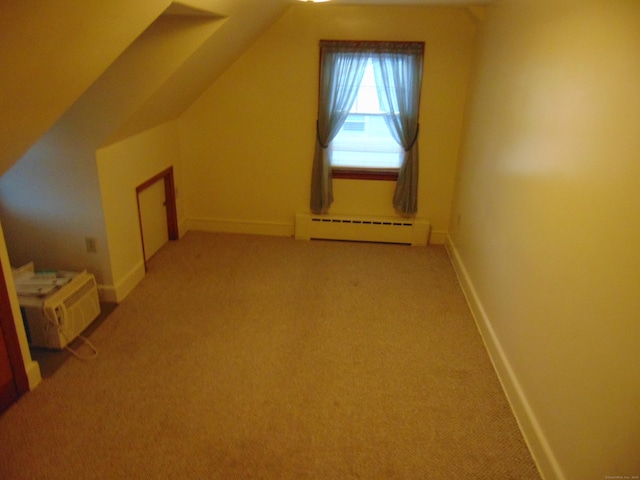 bonus room with a baseboard heating unit, vaulted ceiling, and light colored carpet