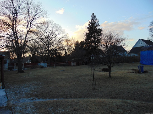 view of yard at dusk