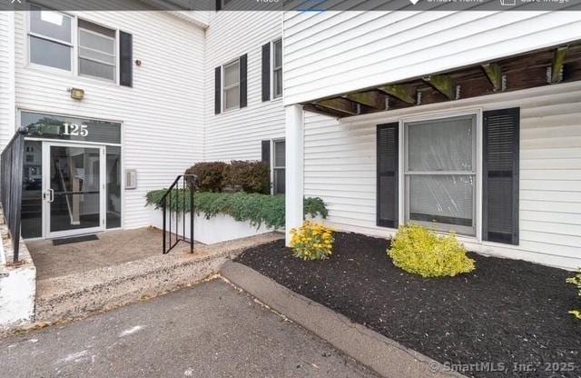 property entrance featuring a patio