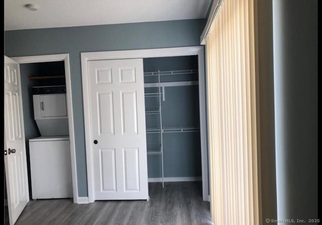 closet with stacked washing maching and dryer