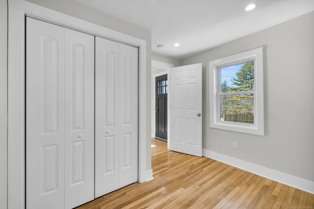 unfurnished bedroom with light hardwood / wood-style floors and a closet