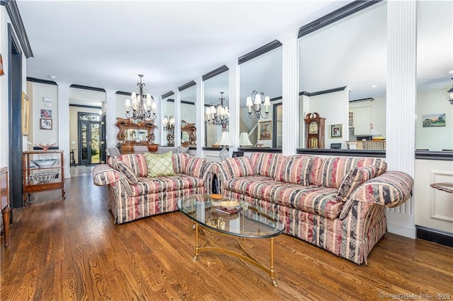 living room featuring wood-type flooring, a chandelier, and ornate columns