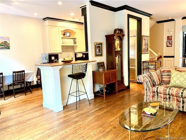 interior space featuring crown molding and light hardwood / wood-style flooring