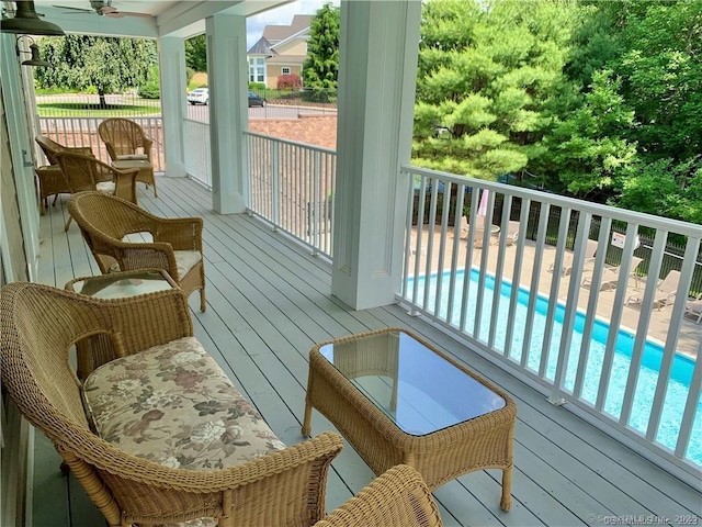 wooden terrace with ceiling fan and a patio