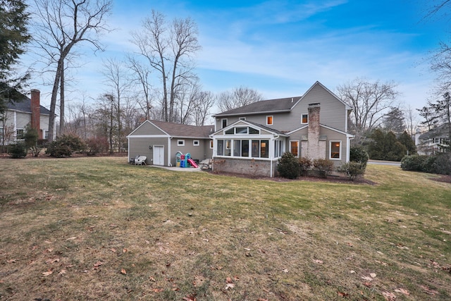 back of house with a sunroom and a yard