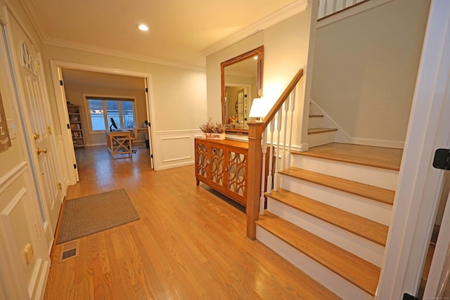 hall with crown molding and hardwood / wood-style flooring