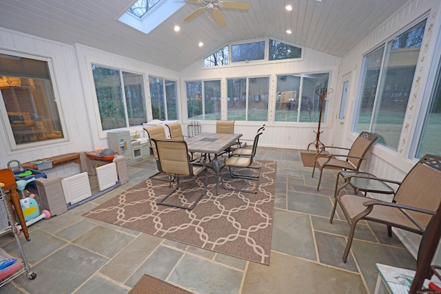 sunroom / solarium with ceiling fan, vaulted ceiling with skylight, and wood ceiling