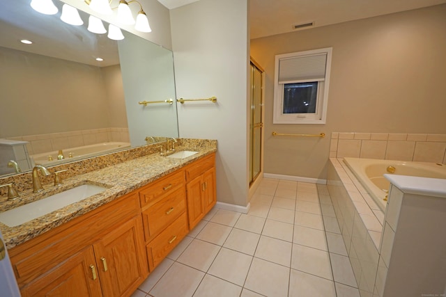 bathroom with vanity, tile patterned floors, and tiled tub