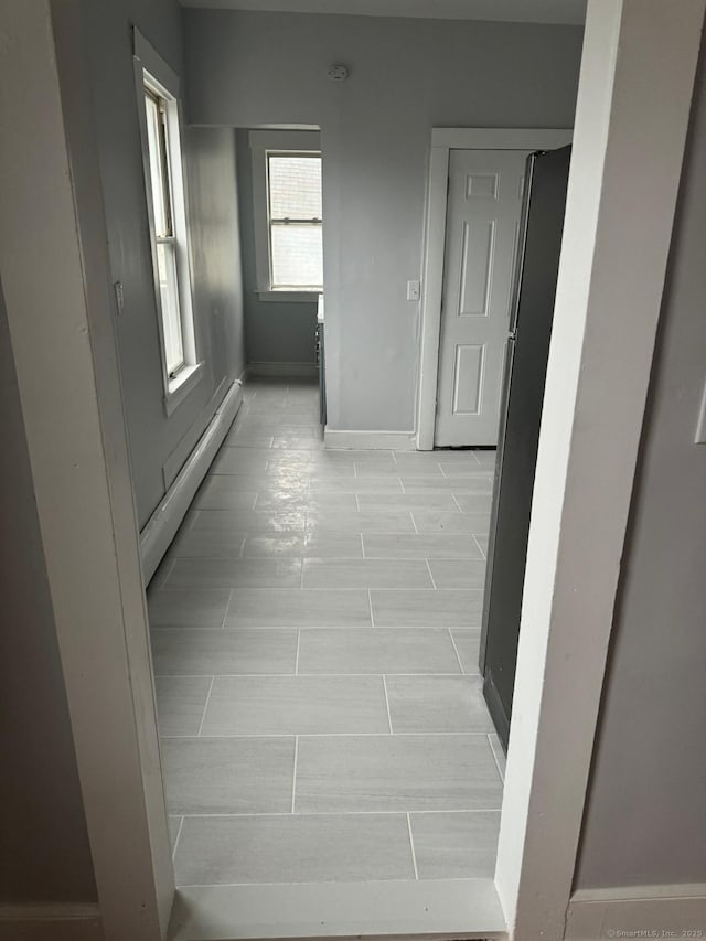 hallway with a baseboard heating unit