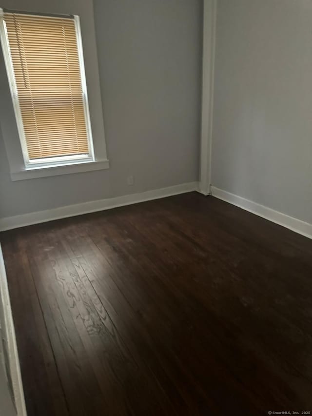 empty room with dark hardwood / wood-style floors