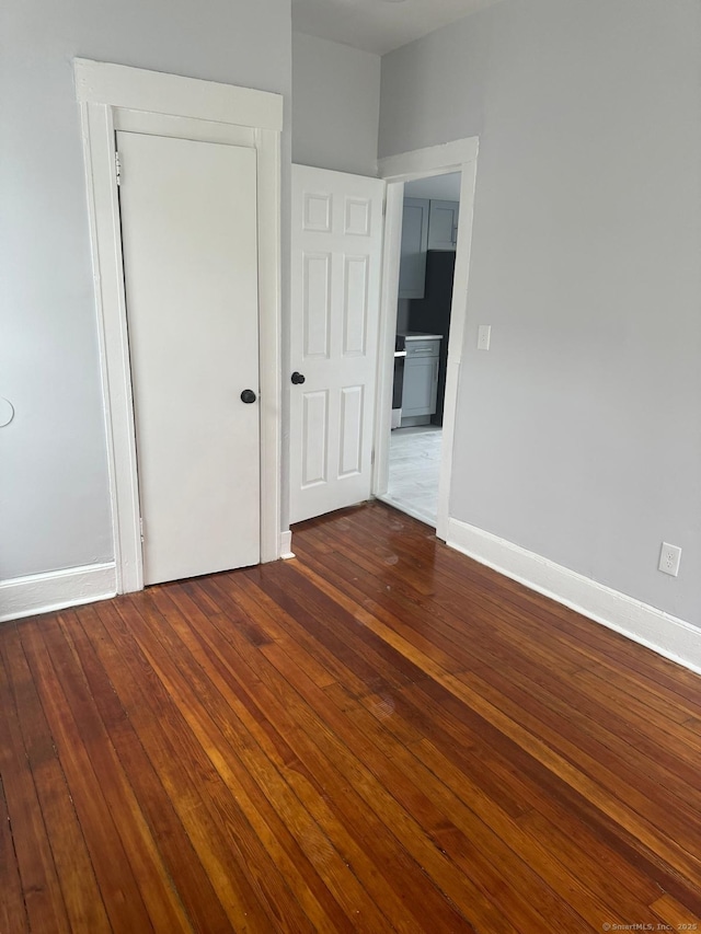 empty room featuring dark wood-type flooring