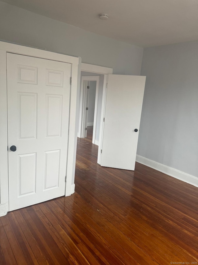 spare room featuring dark hardwood / wood-style flooring