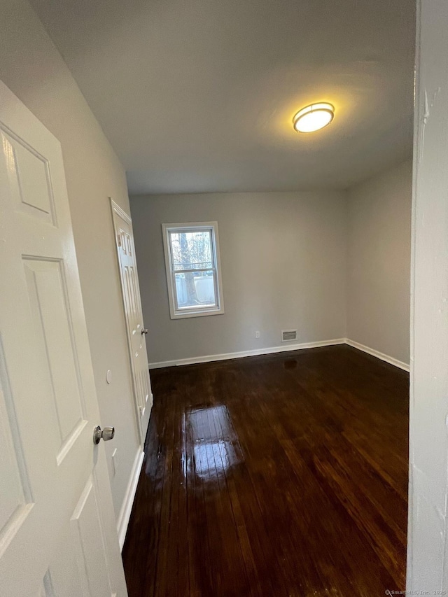 empty room featuring dark hardwood / wood-style flooring