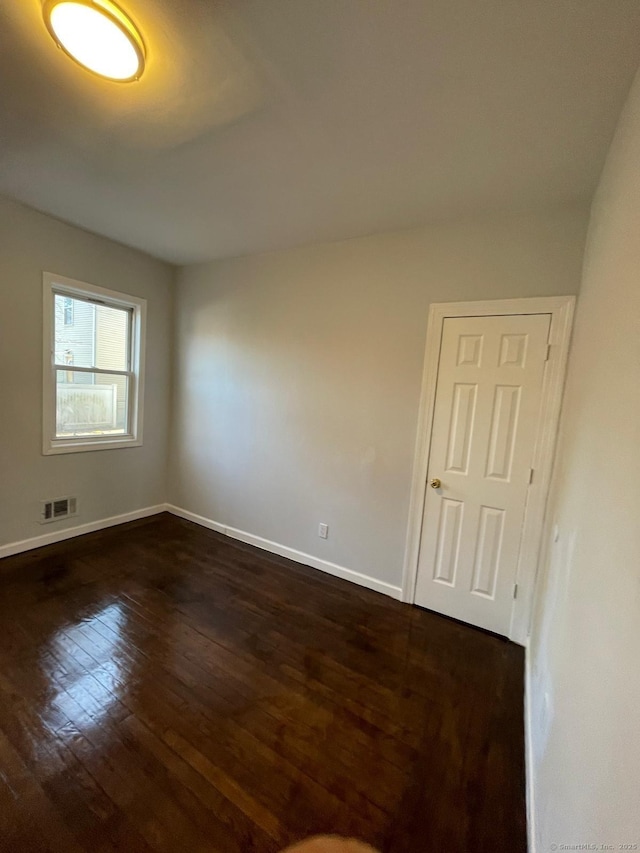 spare room featuring dark hardwood / wood-style floors