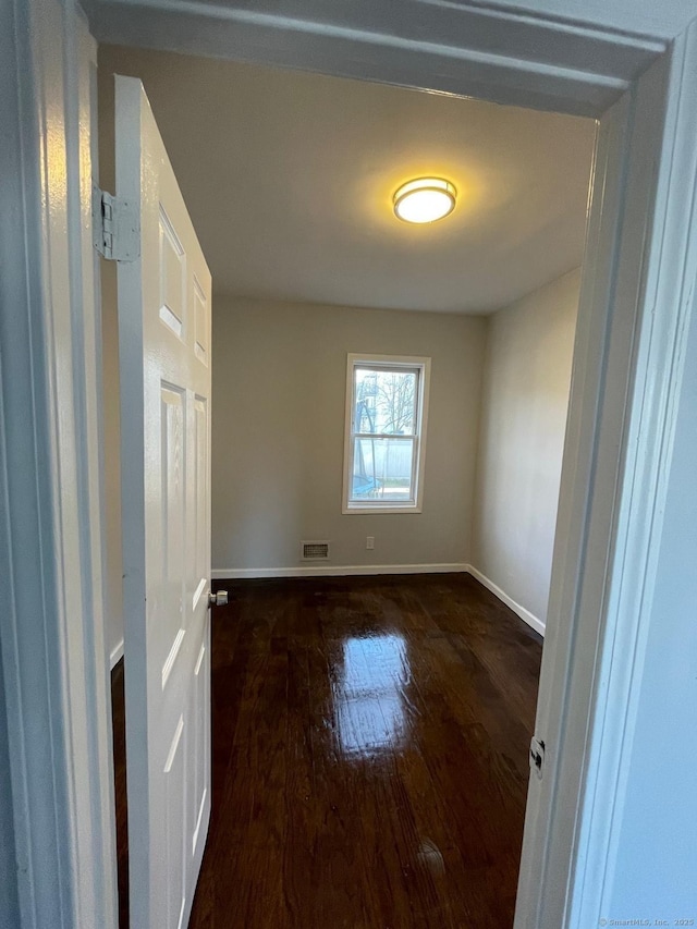 empty room featuring dark hardwood / wood-style floors