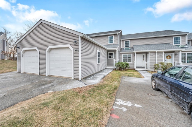 view of front facade with a front yard and a garage