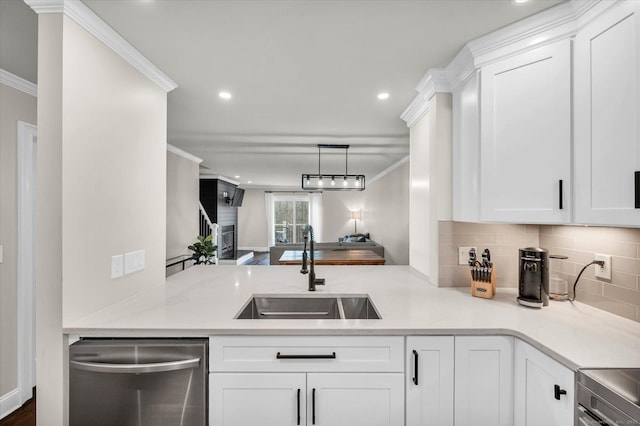 kitchen with white cabinets, decorative backsplash, sink, stainless steel dishwasher, and crown molding