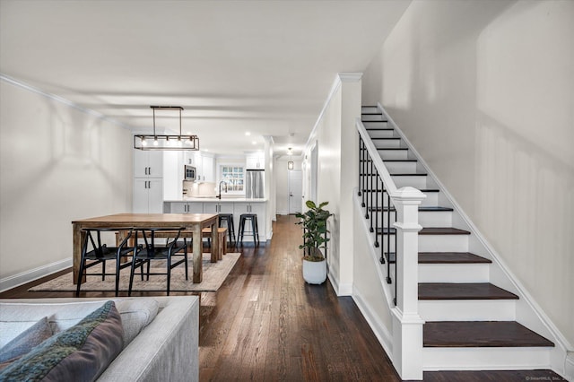 interior space featuring hardwood / wood-style flooring, sink, and crown molding