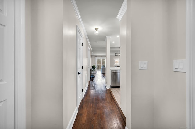 corridor featuring dark hardwood / wood-style floors and crown molding