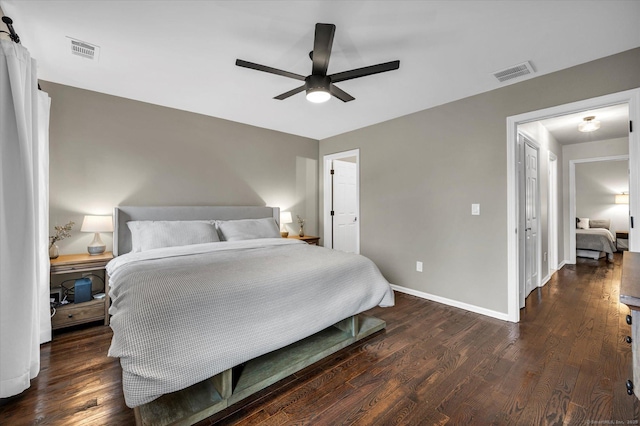 bedroom with ceiling fan and dark wood-type flooring