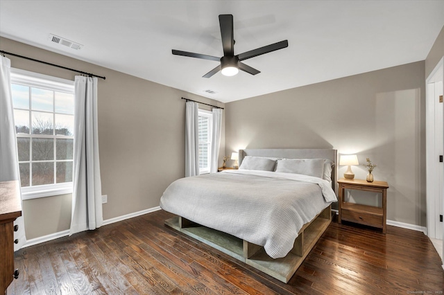 bedroom with ceiling fan and dark hardwood / wood-style flooring