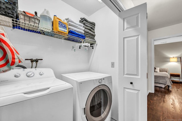 clothes washing area featuring dark hardwood / wood-style floors and independent washer and dryer