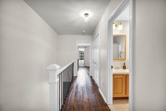 hall with hardwood / wood-style floors and sink