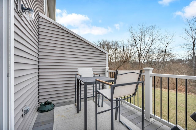 wooden terrace featuring a yard